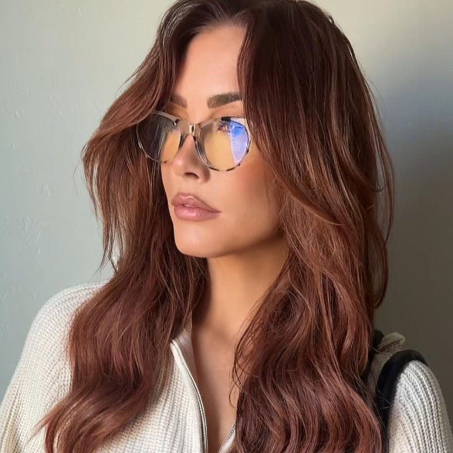 lifestyle -red head wearing nude lipstick and jade cream tort blue light glasses