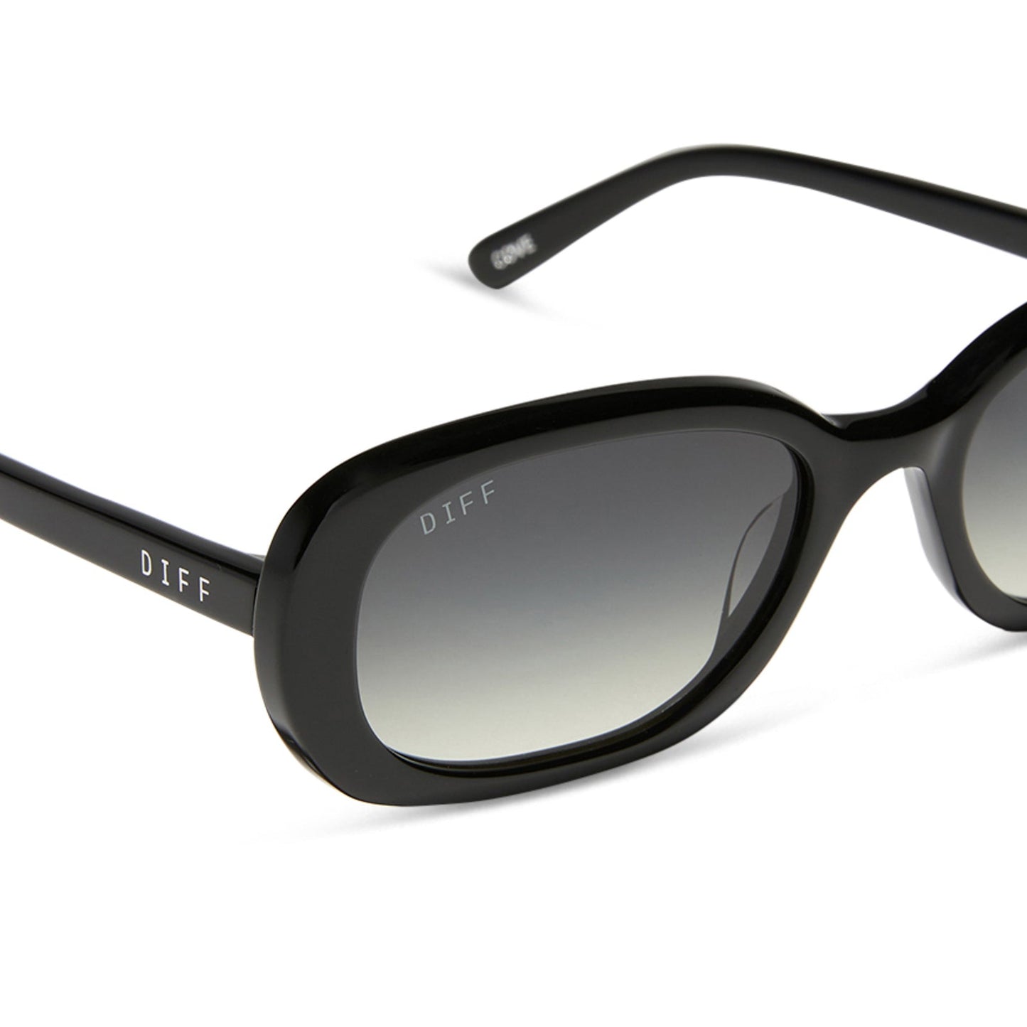 aspyn ovard x diff eyewear featuring the cove oval sunglasses with a black frame and grey gradient lenses detailed view