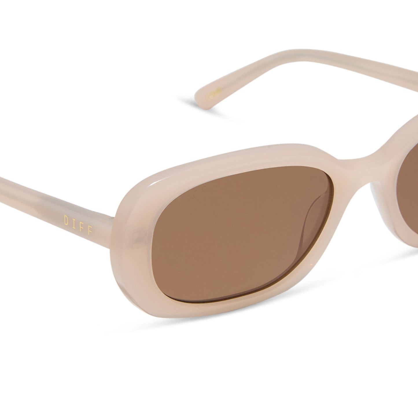 aspyn ovard x diff eyewear featuring the cove oval sunglasses with a milky blush frame and brown lenses detailed view