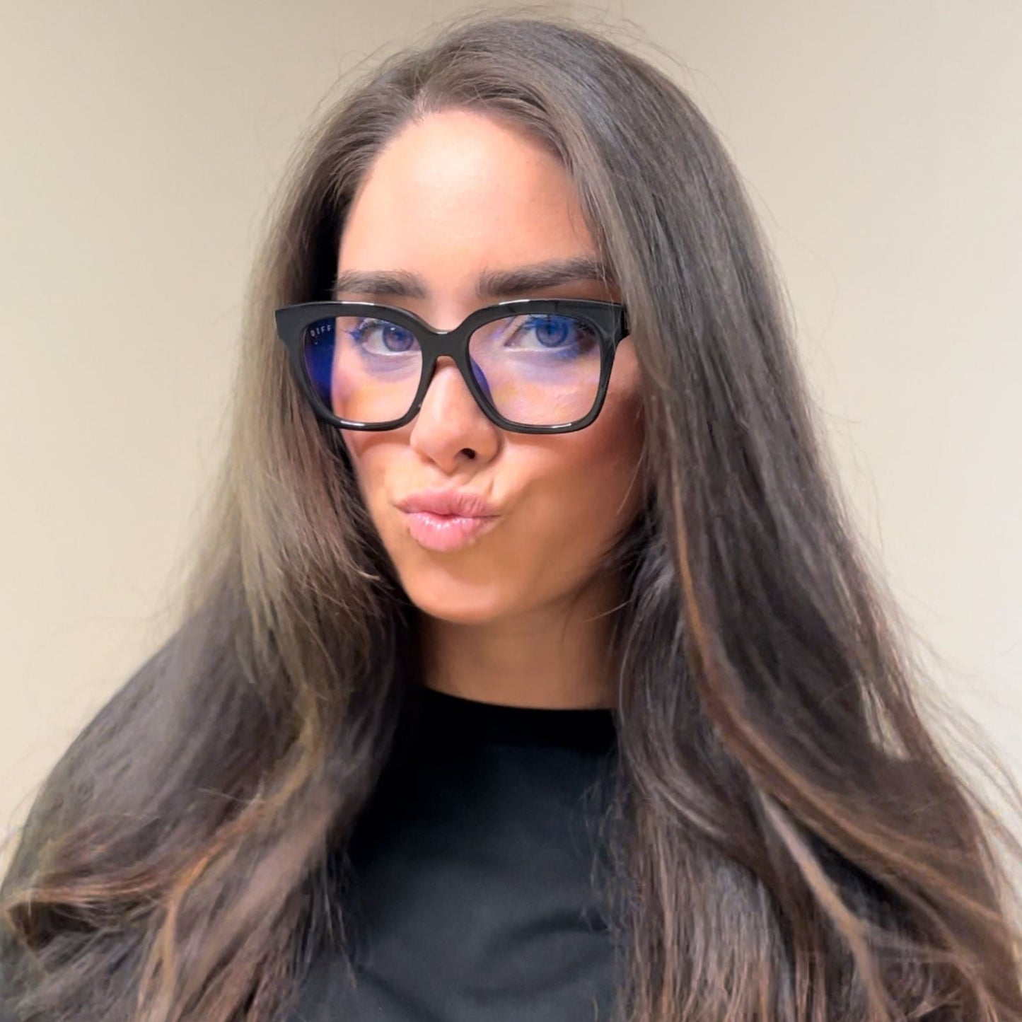 customer content - brunette female wearing black blue light glasses