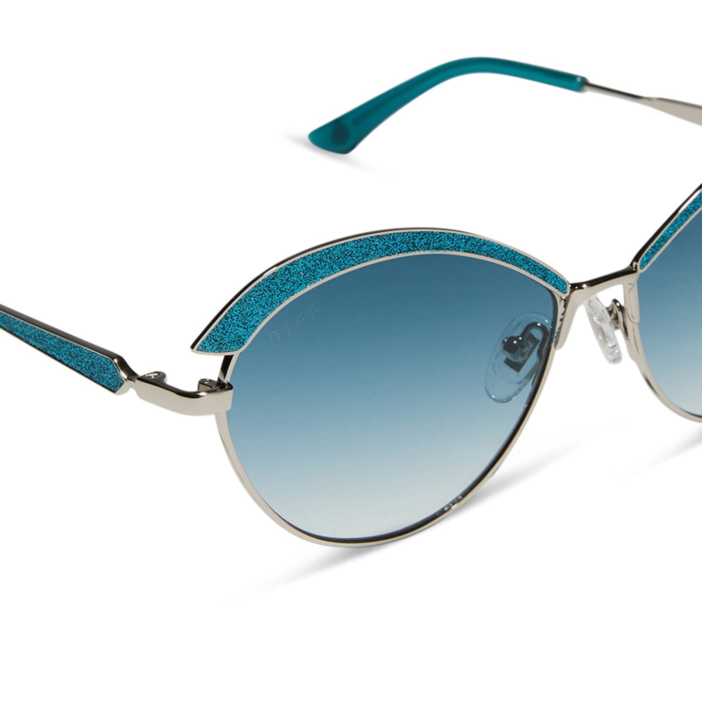 wednesday x diff eyewear featuring the bianca cat eye sunglasses with a silver frame and teal gradient lenses detailed view