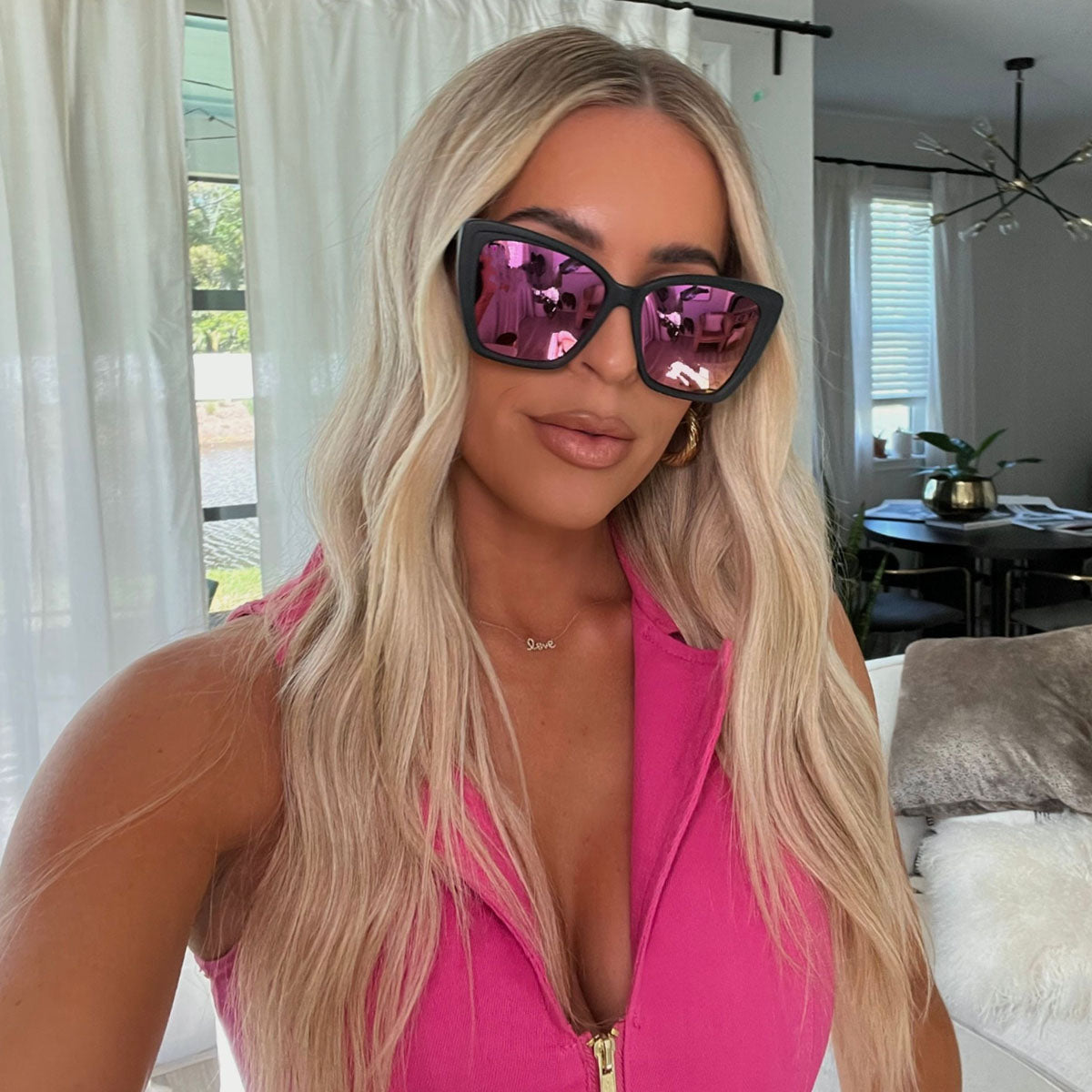 lifestyle - Brooke Wytiaz wearing the DIFF Eyewear Becky II cat eye sunglasses with a matte black frame and pink mirror polarized lenses