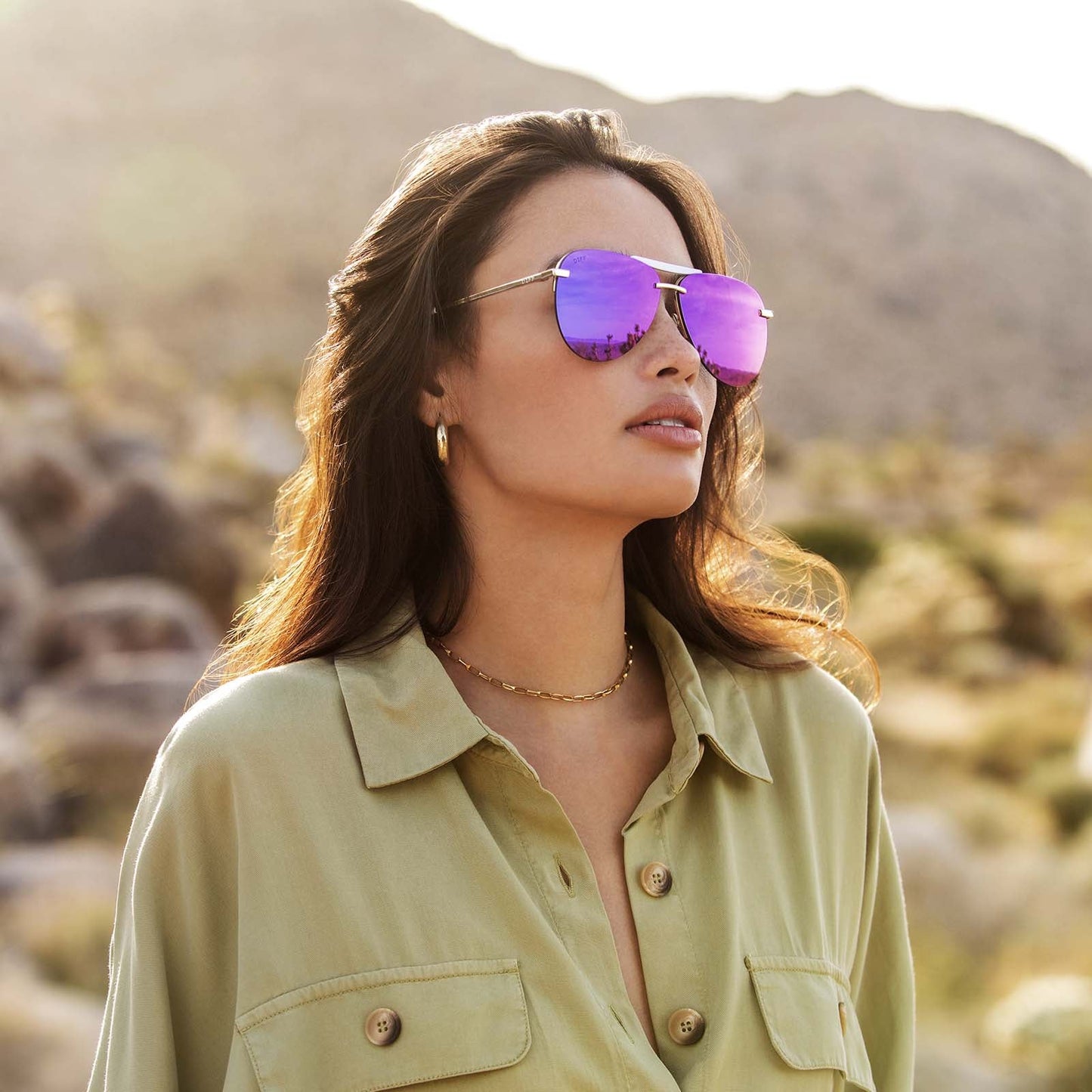 Tahoe gold frame and purple mirror lens on brunette model
