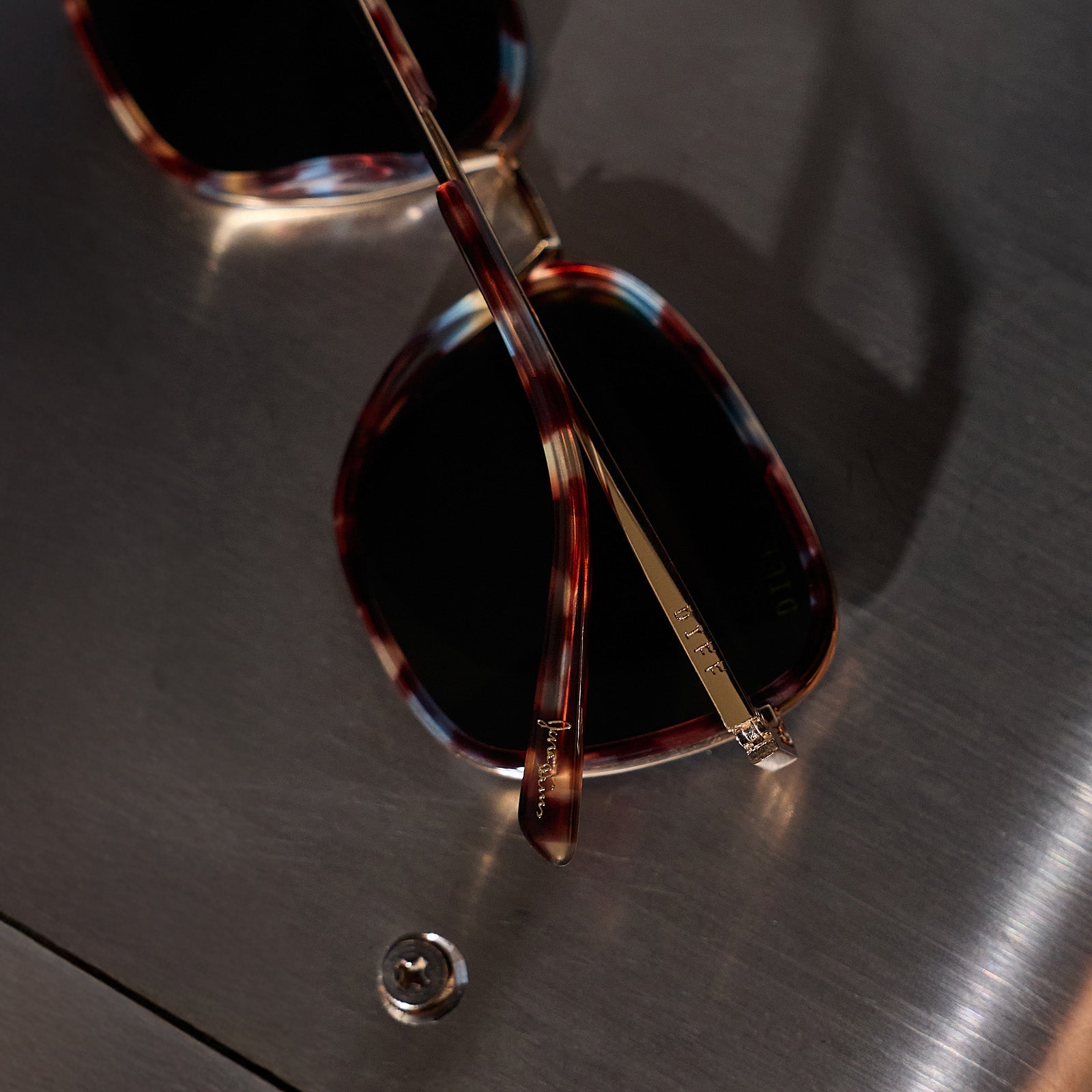 still life of jena sims x diff eyewear hope cat eye sunglasses with a blue color pop frame and g15 polarized lenses detailed view