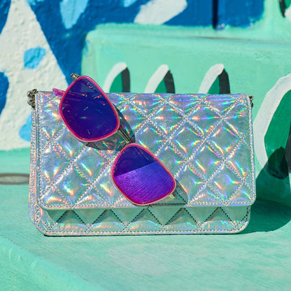 still life - jena sims x diff eyewear the hope cat eye sunglasses with a hot pink and gold frame and hot pink mirror lenses  hanging on a purse