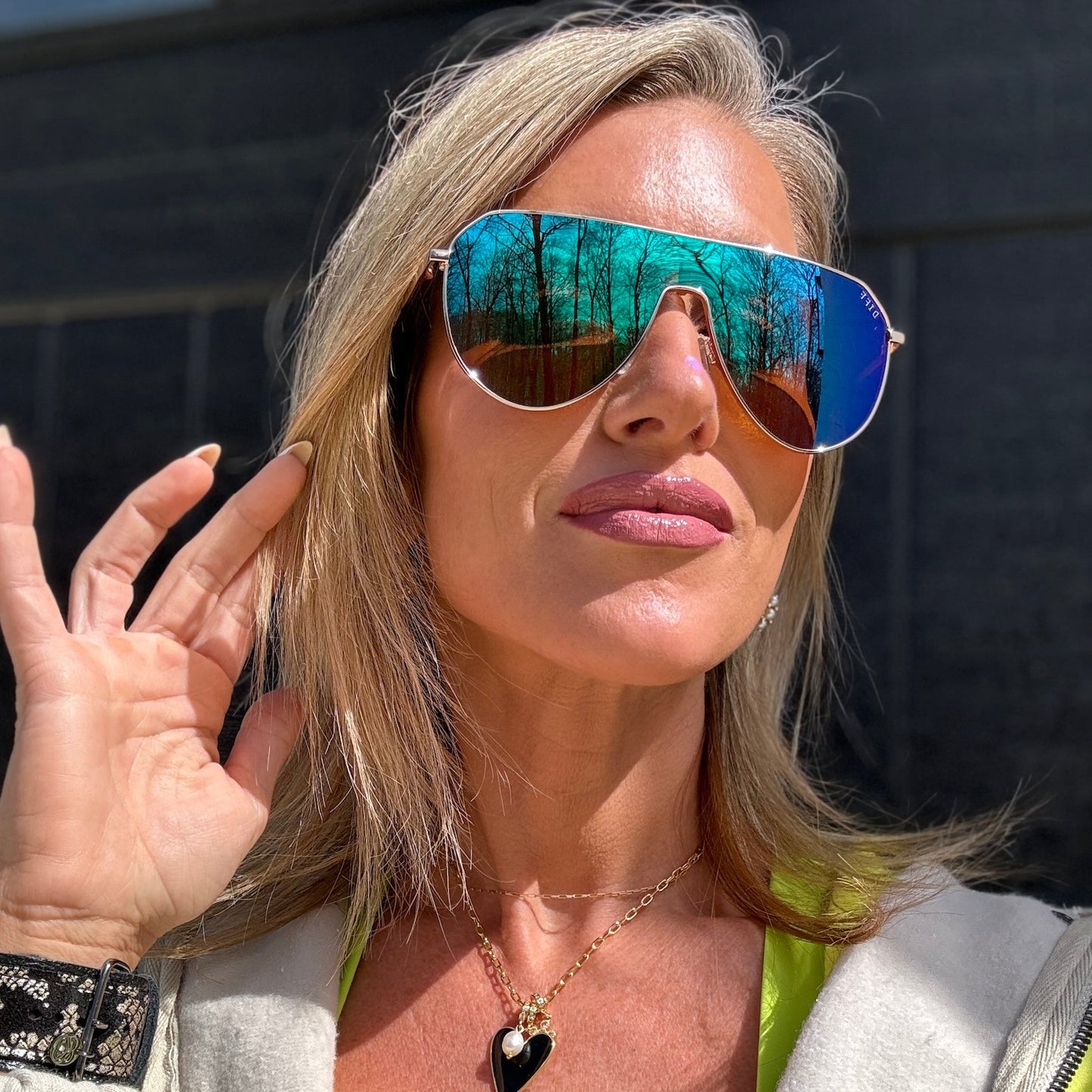 customer content - kalee rogers wearing dash shield sunglasses with a gold frame and green mirror lenses front view