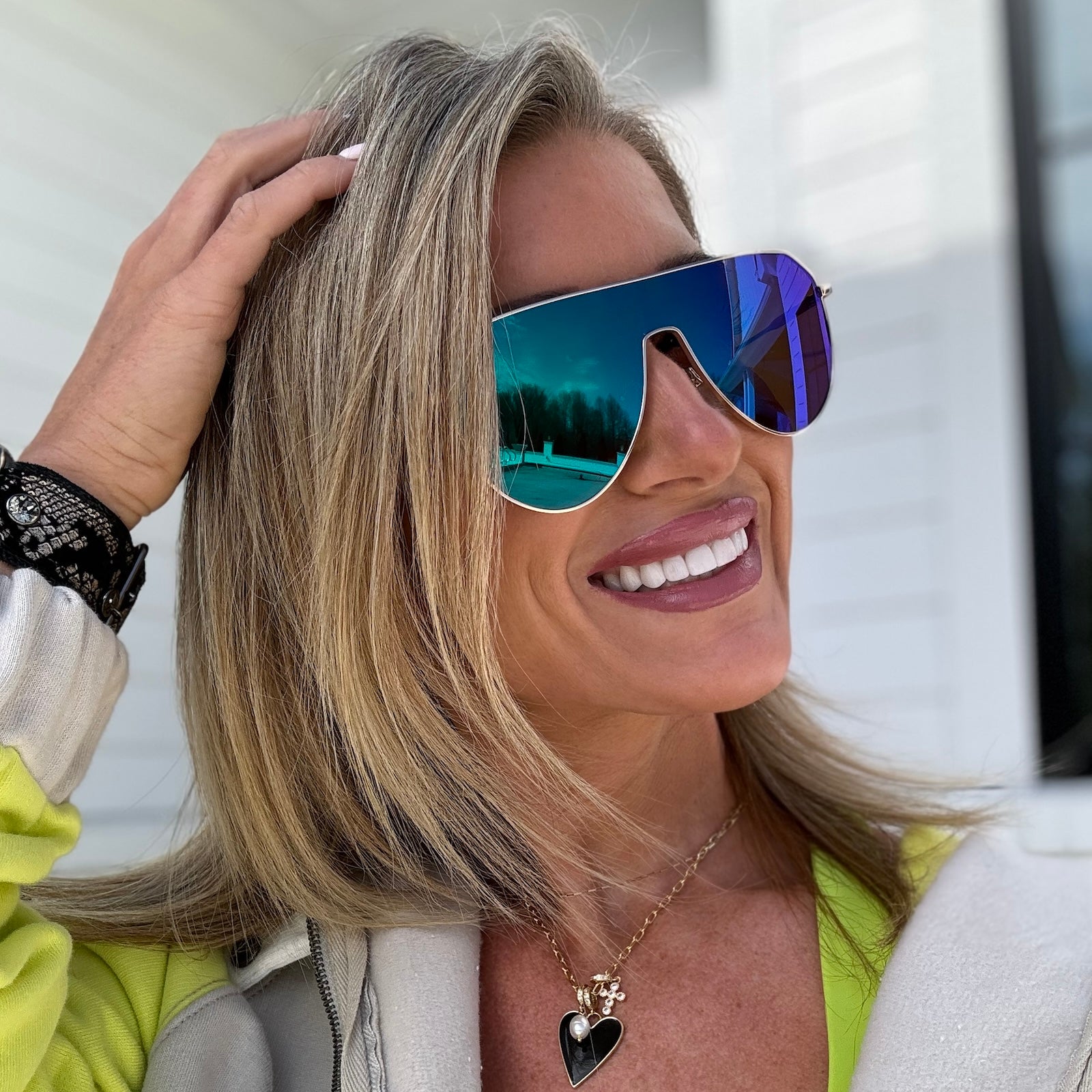 customer content - kalee rogers wearing dash shield sunglasses with a gold frame and green mirror lenses front view