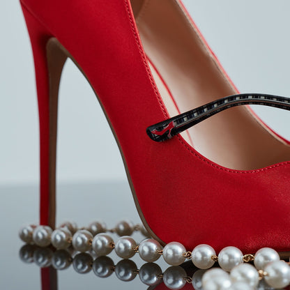 still life of devil wears prada red stiletto shoe with diff eyewear pearl chain