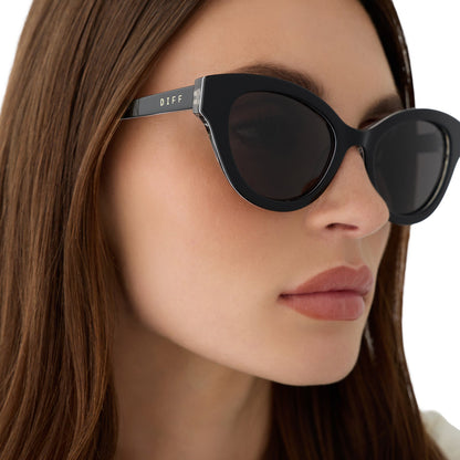 on model - close up view of female wearing devil wears prada x diff eyewear andy in black sunglasses