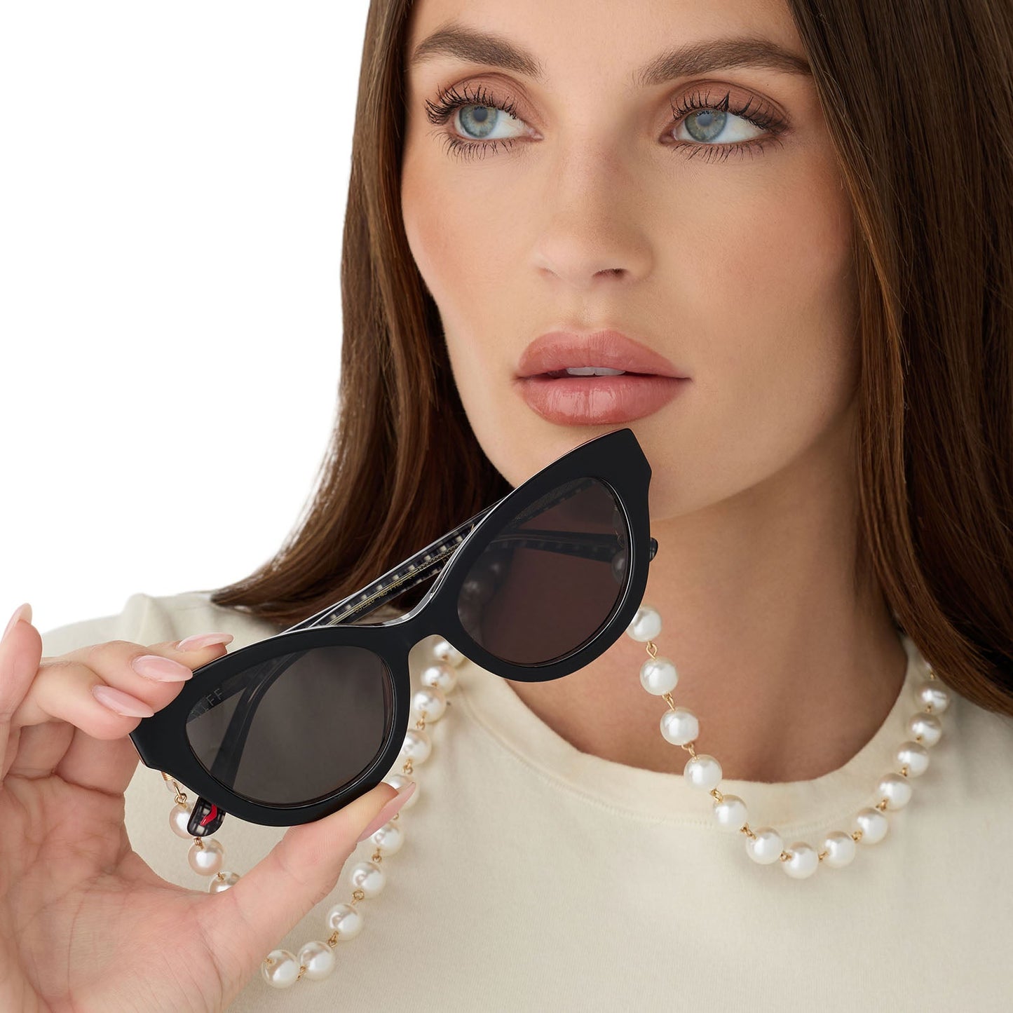 on model - close up view of nicely dressed female wearing devil wears prada x diff eyewear andy in black sunglasses with pearl chain