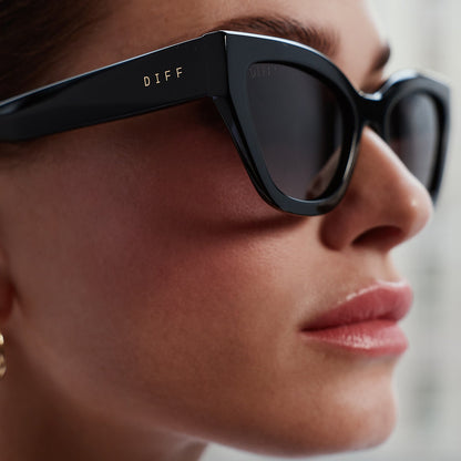 on model - detailed view of female wearing devil wears prada x diff eyewear emily black acetate sunglasses