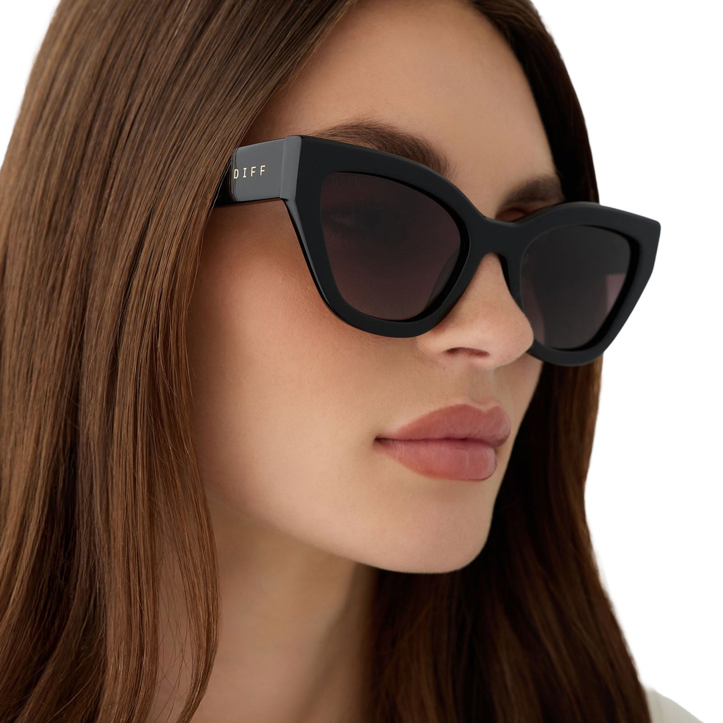 on model - female wearing the devil wears prada x diff eyewear featuring the emily cat eye sunglasses with a black acetate frame and grey gradient polarized lenses angled view