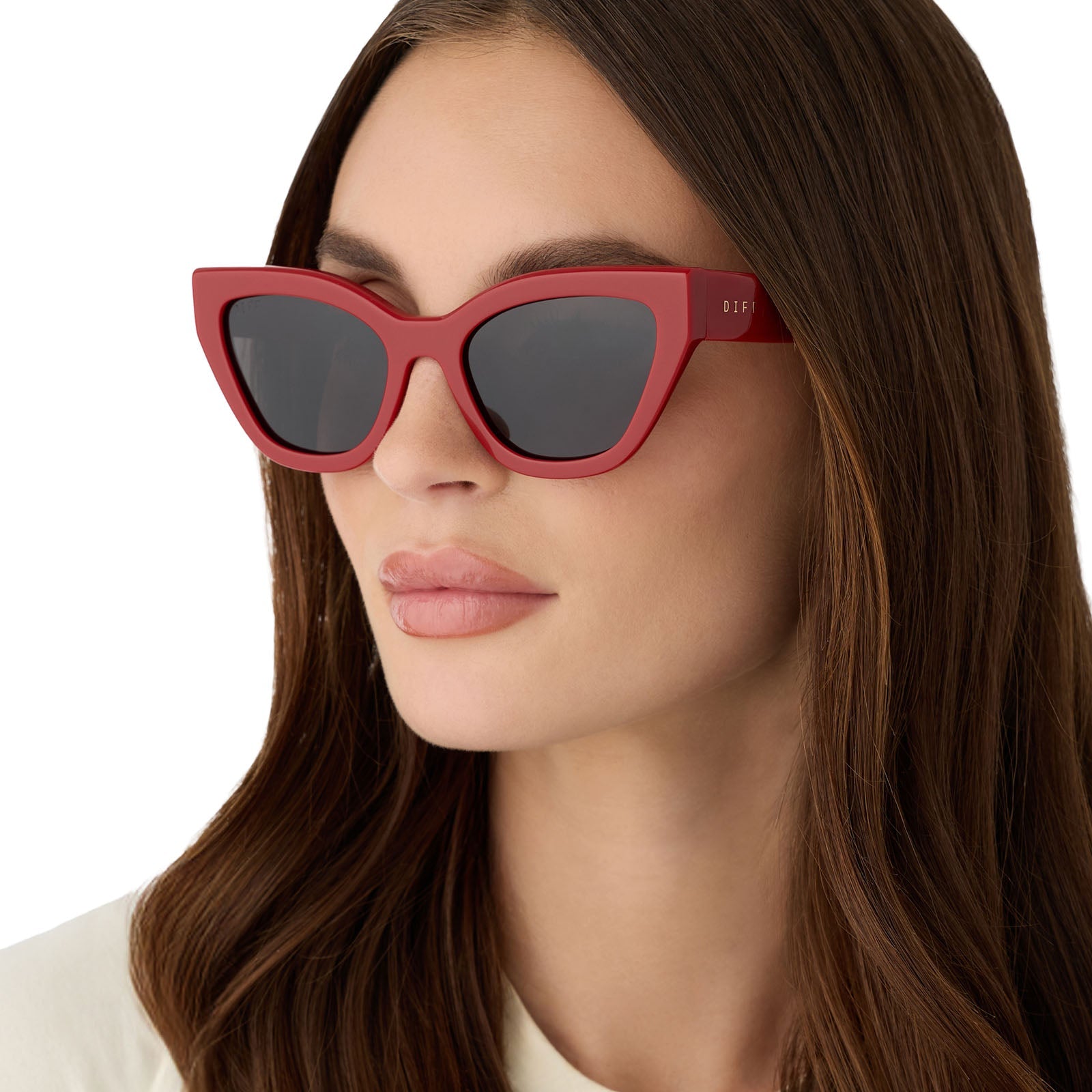 on model - female wearing the devil wears prada x diff eyewear featuring the emily cat eye sunglasses with a red acetate frame and grey polarized lenses angled view