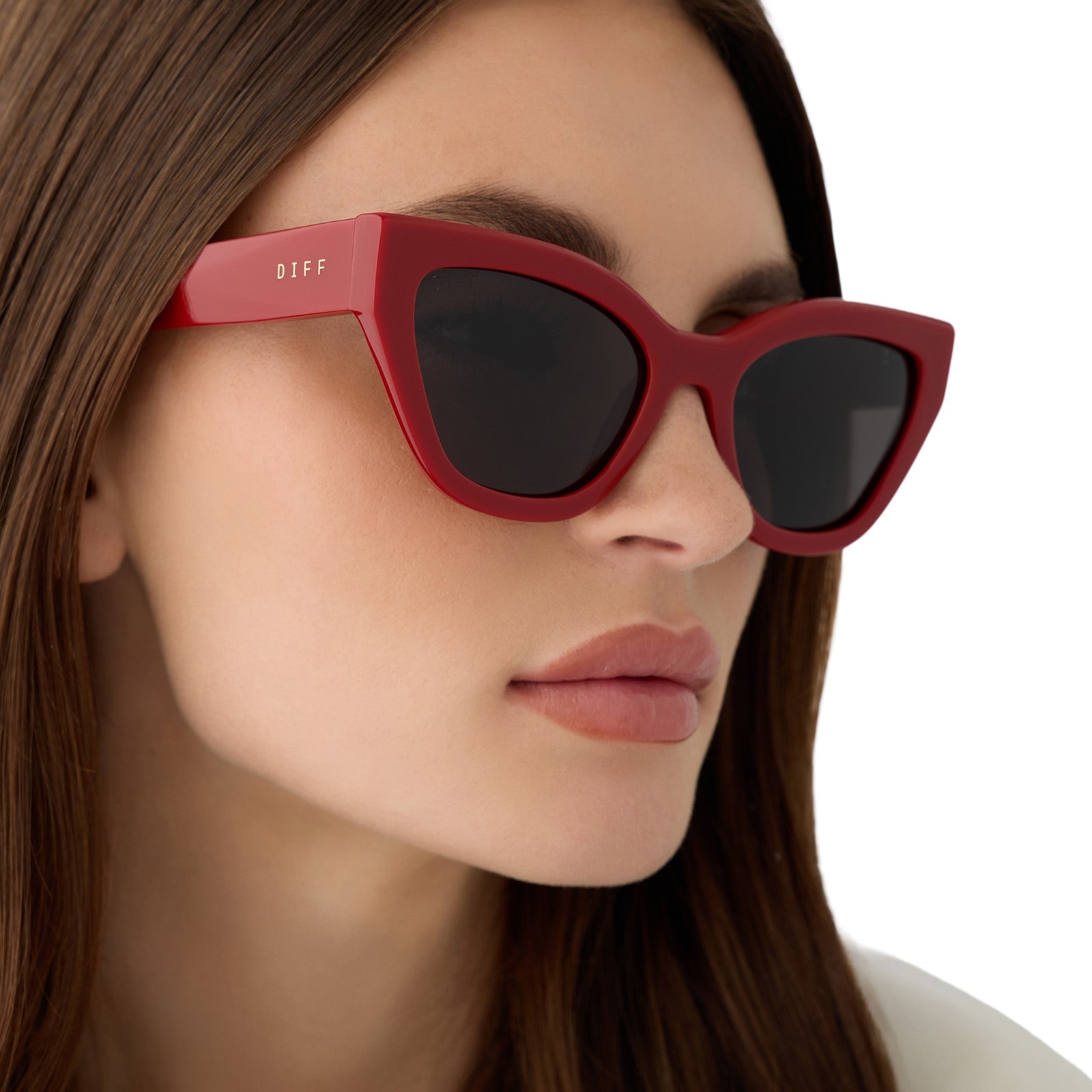 on model - female wearing the devil wears prada x diff eyewear featuring the emily cat eye sunglasses with a red acetate frame and grey polarized lenses side view