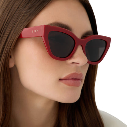 on model - female wearing the devil wears prada x diff eyewear featuring the emily cat eye sunglasses with a red acetate frame and grey polarized lenses side view