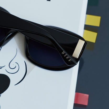 still life - the devil wears prada x diff eyewear mirana glasses resting on a play bill