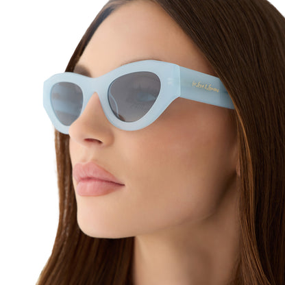 on model - female wearing for love and lemons x diff eyewear featuring the lucy cat eye sunglasses with a pastel blue frame and blue gradient polarized lenses detailed  view