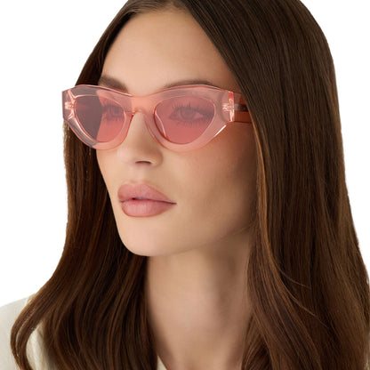 on model - female wearing for love and lemons x diff eyewear featuring the lucy cat eye sunglasses with a pastel pink frame and rose lenses angled view