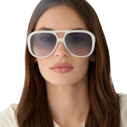 on model - female wearing for love and lemons x diff eyewear featuring the pauline aviator sunglasses with a meringue cream frame and blue gradient lenses front view
