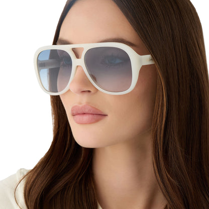 on model - female wearing for love and lemons x diff eyewear featuring the pauline aviator sunglasses with a meringue cream frame and blue gradient lenses detailed view