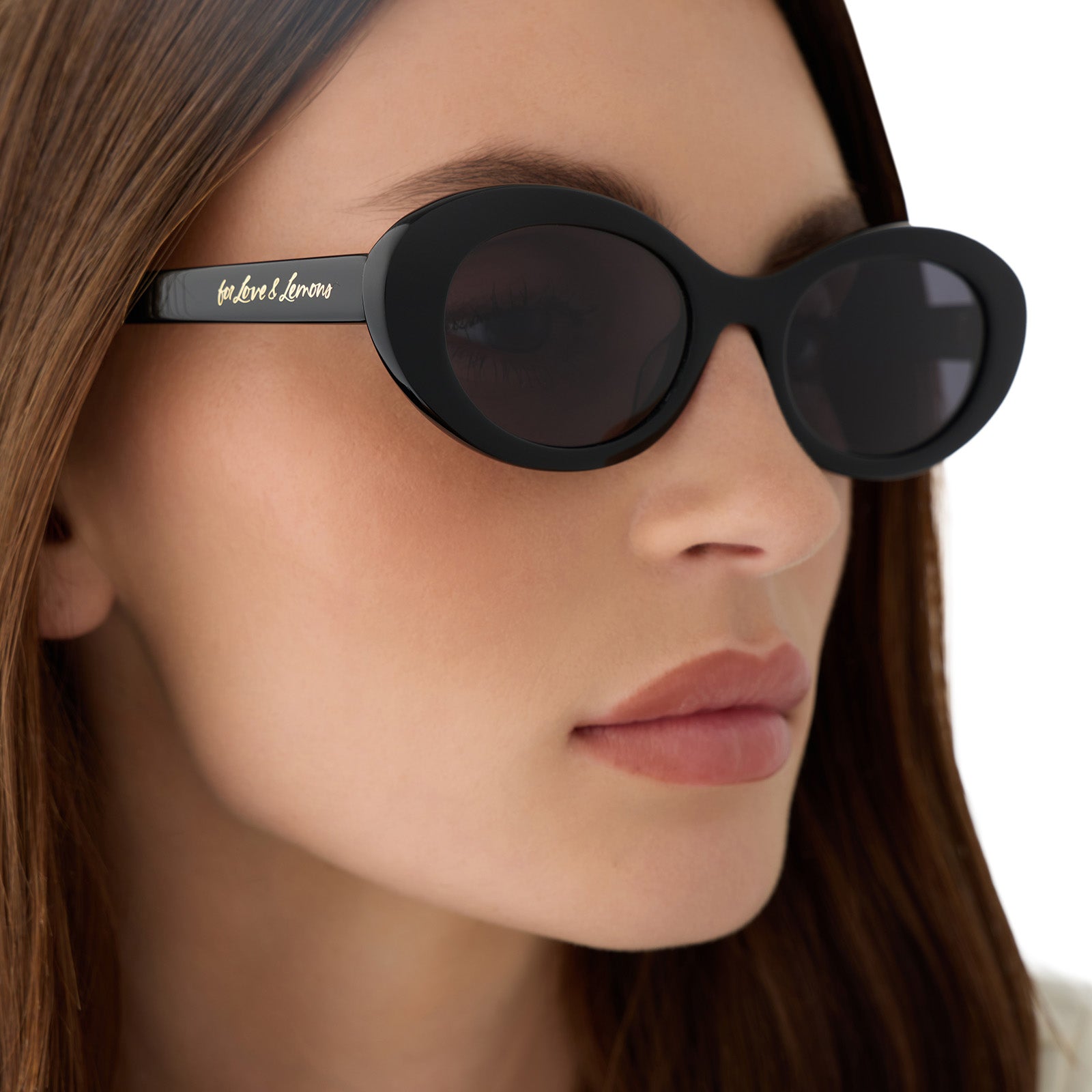 on model - female wearing for love and lemons x diff eyewear featuring the sabrina oval sunglasses with a black frame and grey polarized lenses detailed view