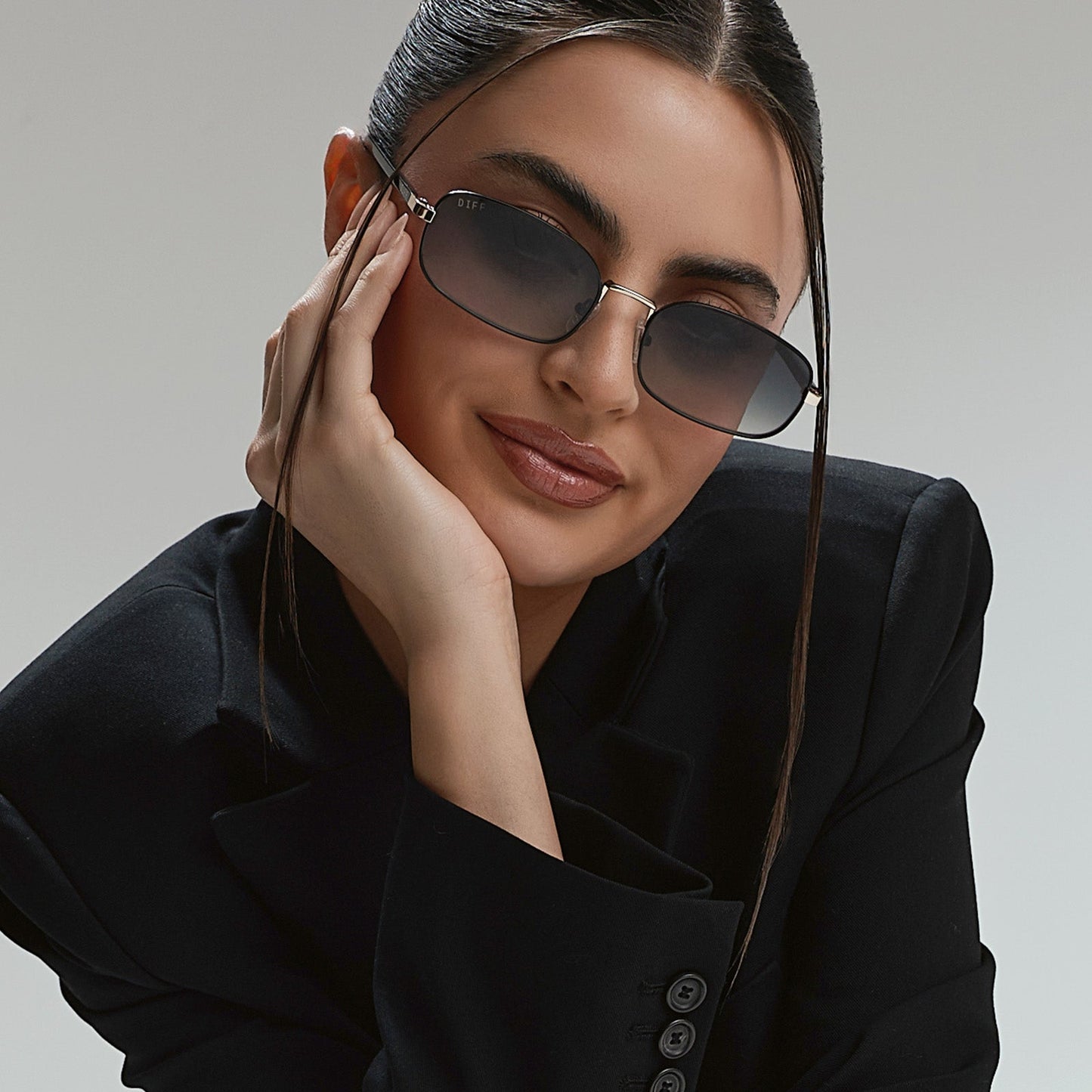 lifestyle - rachael kirkconnell wearing diff eyewear naomi square sunglasses with a black and gold metal frame and grey gradient lenses front view