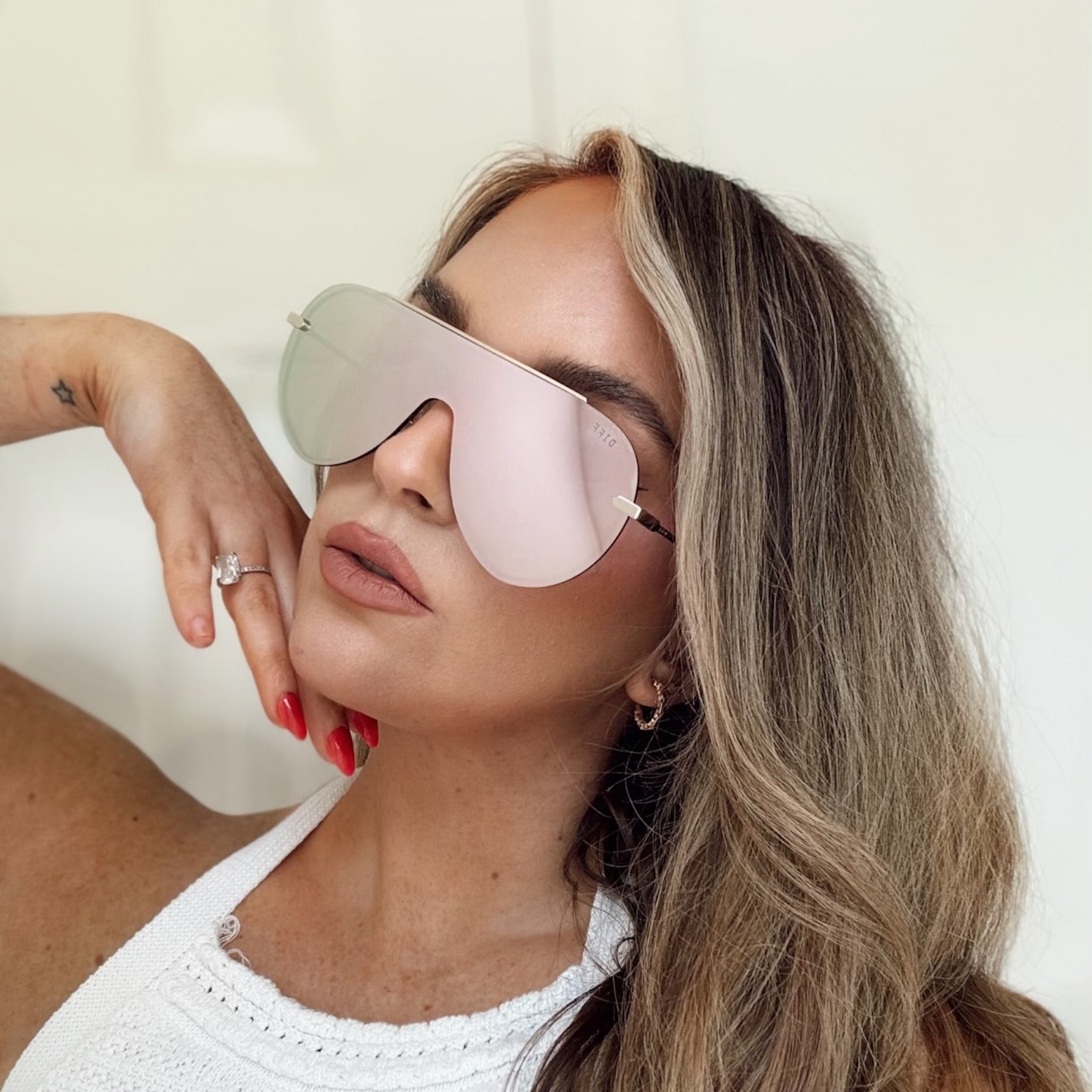 customer content - leasims wearing diff eyewear featuring the imani shield sunglasses with a gold frame and cherry blossom mirror lenses front view