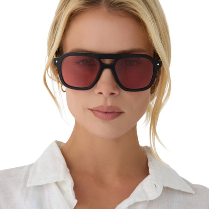 on model - female wearing beach riot x diff eyewear the coast navigator sunglasses with a black acetate frame and red tinted lenses front view