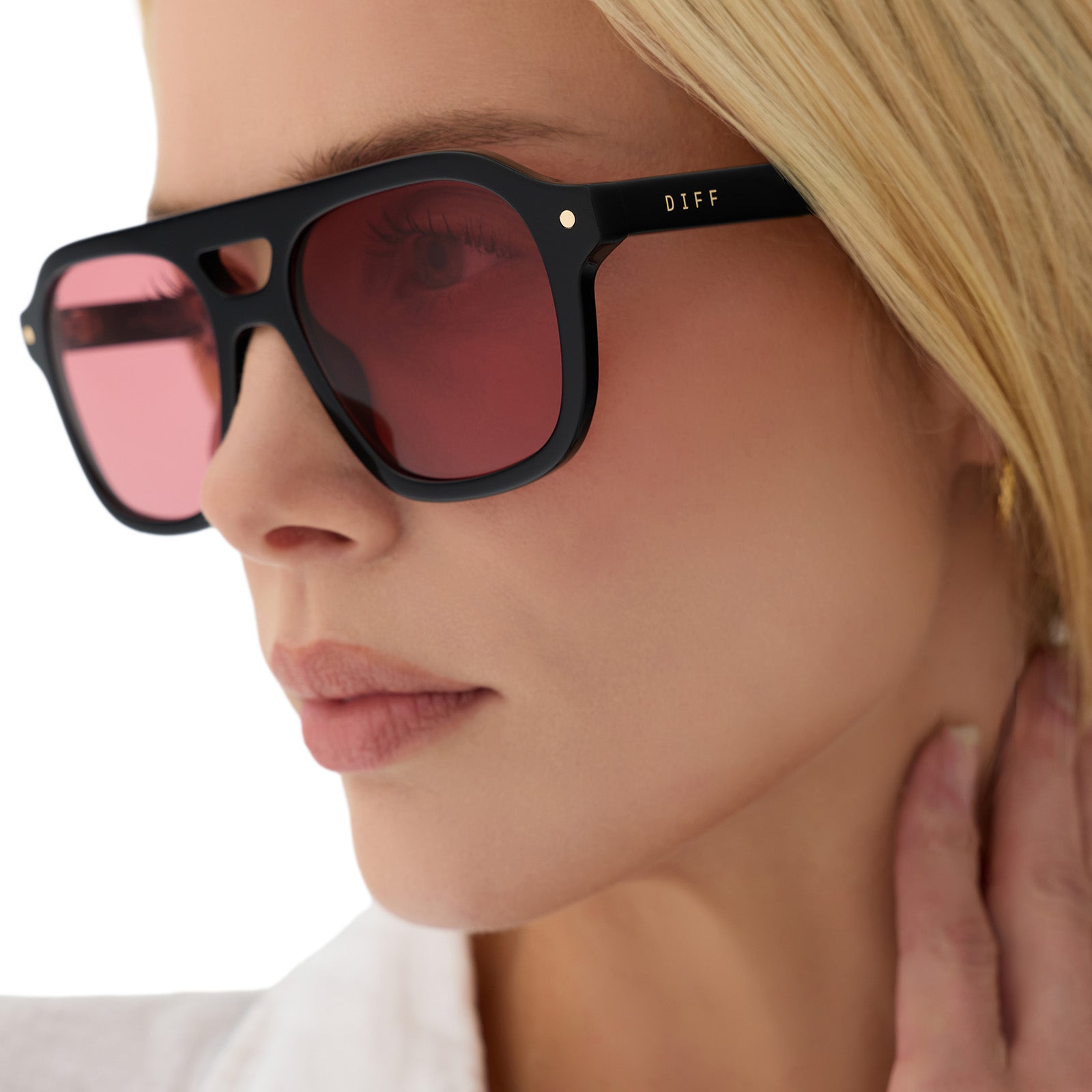 on model - female wearing beach riot x diff eyewear the coast navigator sunglasses with a black acetate frame and red tinted lenses detailed view