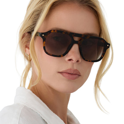 on model - female wearing beach riot x diff eyewear the coast navigator sunglasses with a tortoise acetate frame and brown gradient lenses angled view