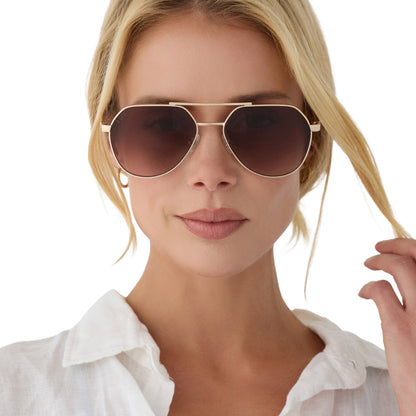 on model - female wearing beach riot x diff eyewear the reserve aviator sunglasses with a gold metal frame and brown gradient lenses front view