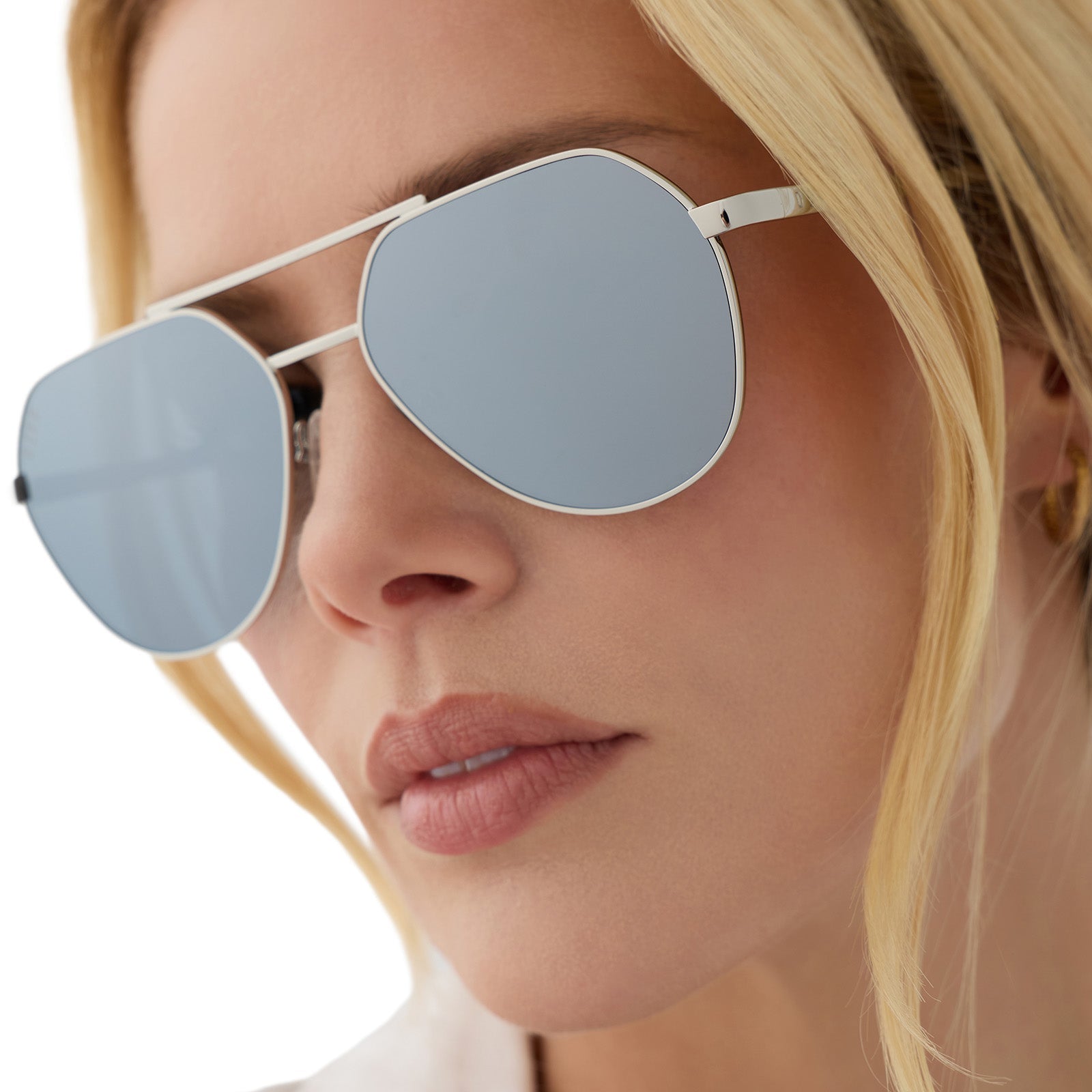 on model - female wearing beach riot x diff eyewear the reserve aviator sunglasses with a silver metal frame and silver mirror lenses detailed view