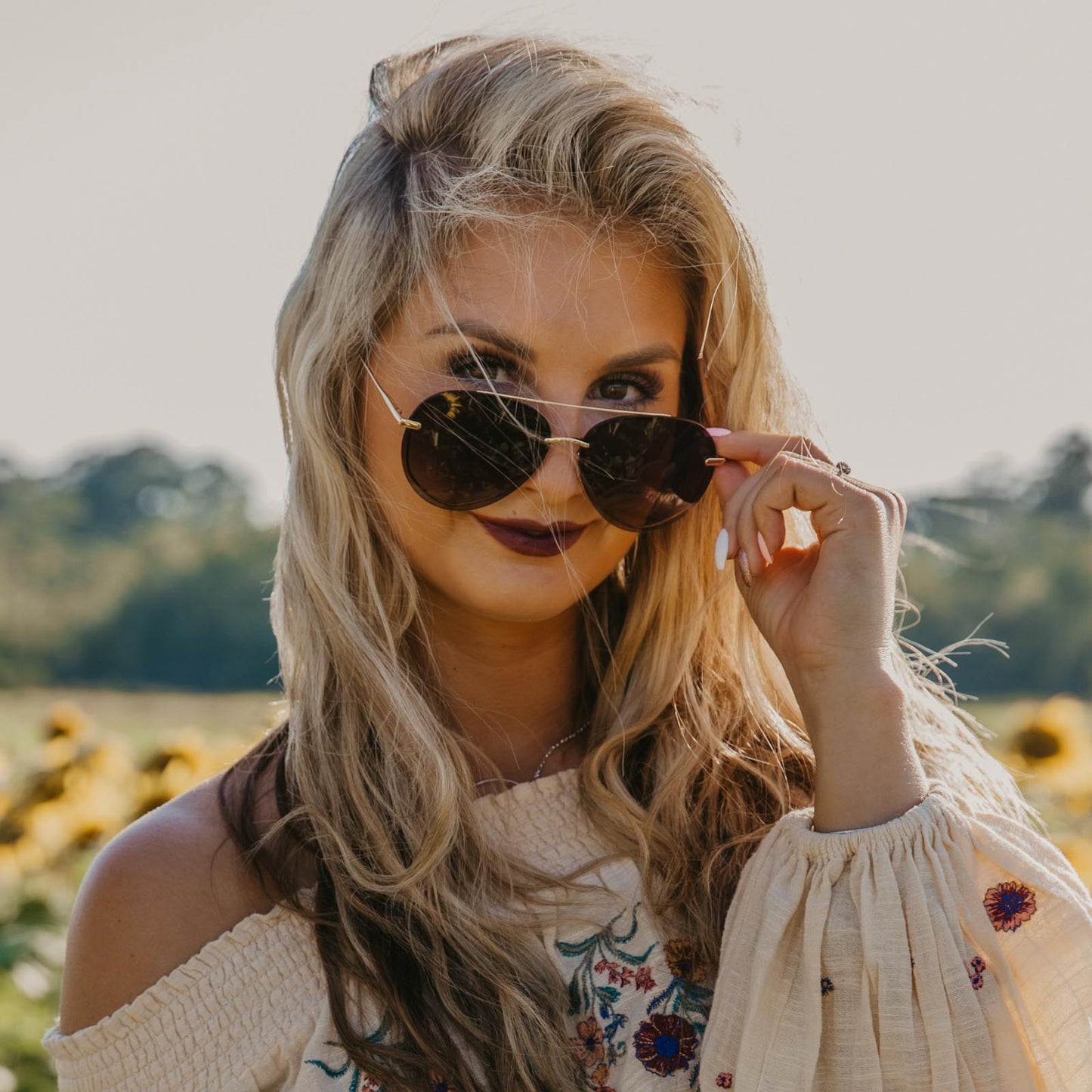 lifestyle - ambermiller9 wearing lenox gold frame with sea tortoise tips and brown gradient lens sunglasses 2