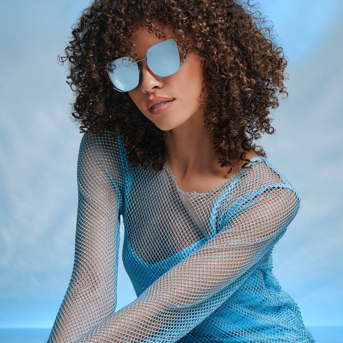 on model - frozen x diff eyewear featuring the elsa oversized square sunglasses with a cool silver gloss metal frame and ice blue gradient lenses angled view
