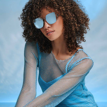 on model - frozen x diff eyewear featuring the elsa oversized square sunglasses with a cool silver gloss metal frame and ice blue gradient lenses angled view