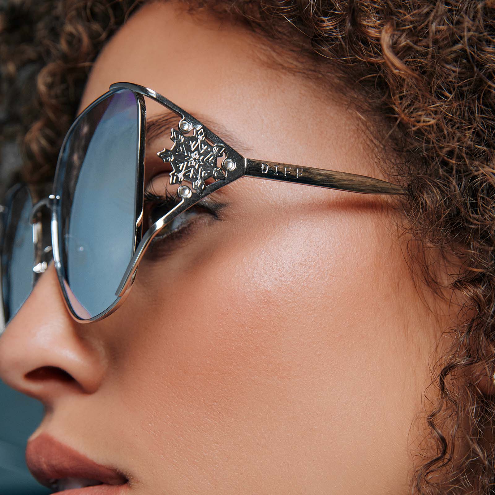 on model - frozen x diff eyewear featuring the elsa oversized square sunglasses with a cool silver gloss metal frame and ice blue gradient lenses detailed temple view
