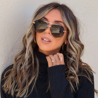 lifestyle - hayleyalaines wearing diff eyewear lenox aviator sunglasses with a gold, black metal frame and grey gradient polarized lenses
