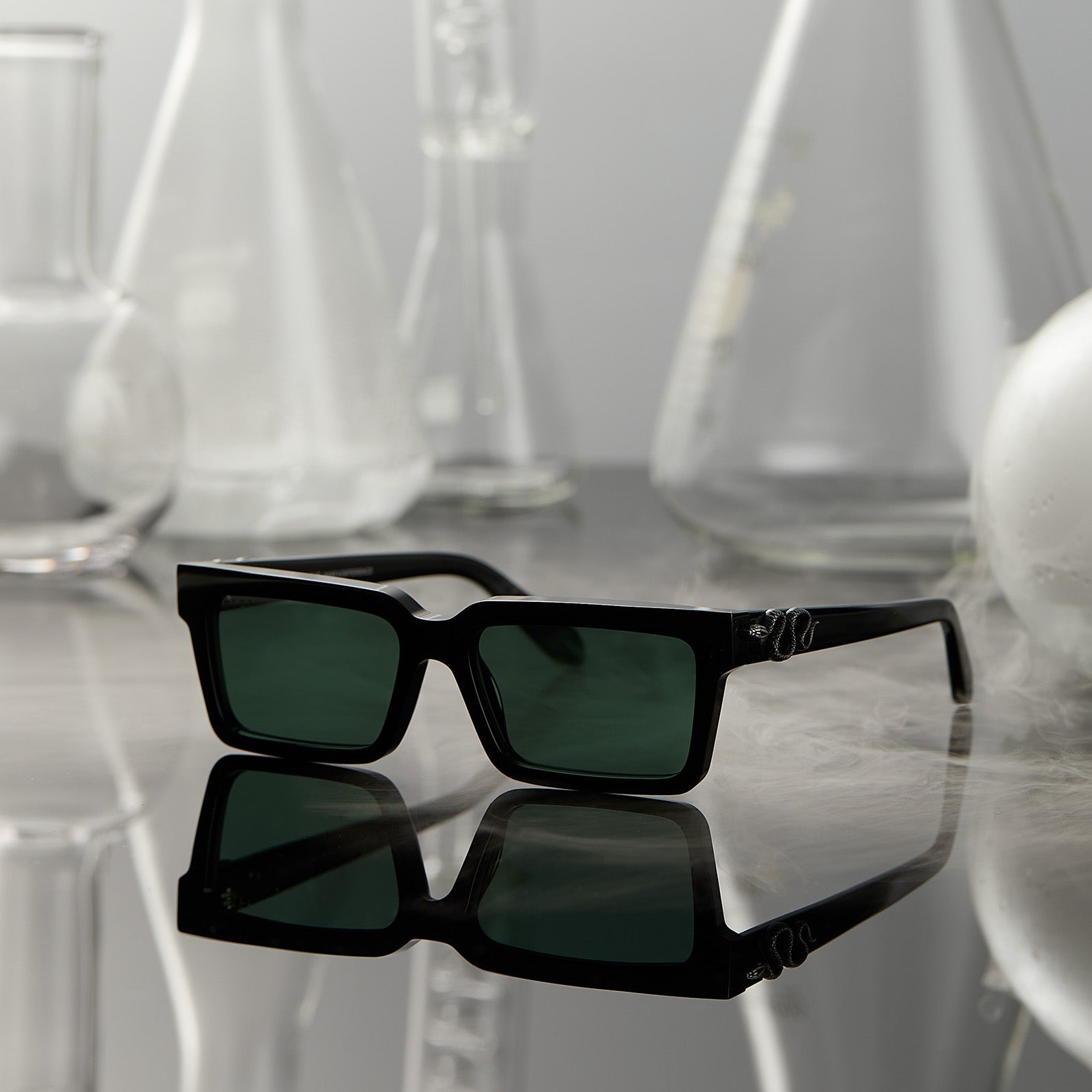 lifestyle - surrounded by potion flask harry potter x diff eyewear featuring professor snape 2.0 square  sunglasses with a black frame and g15 lenses front view
