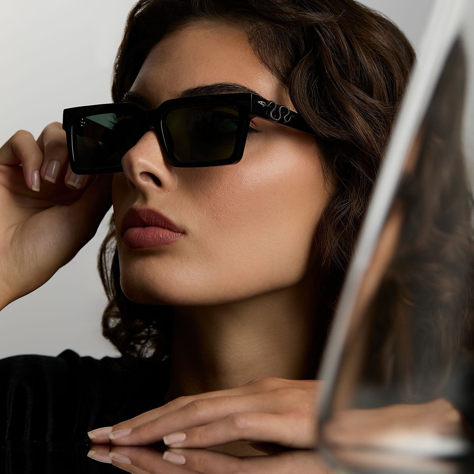 lifestyle - female wearing harry potter x diff eyewear featuring professor snape 2.0 square  sunglasses with a black frame and g15 lenses angled view