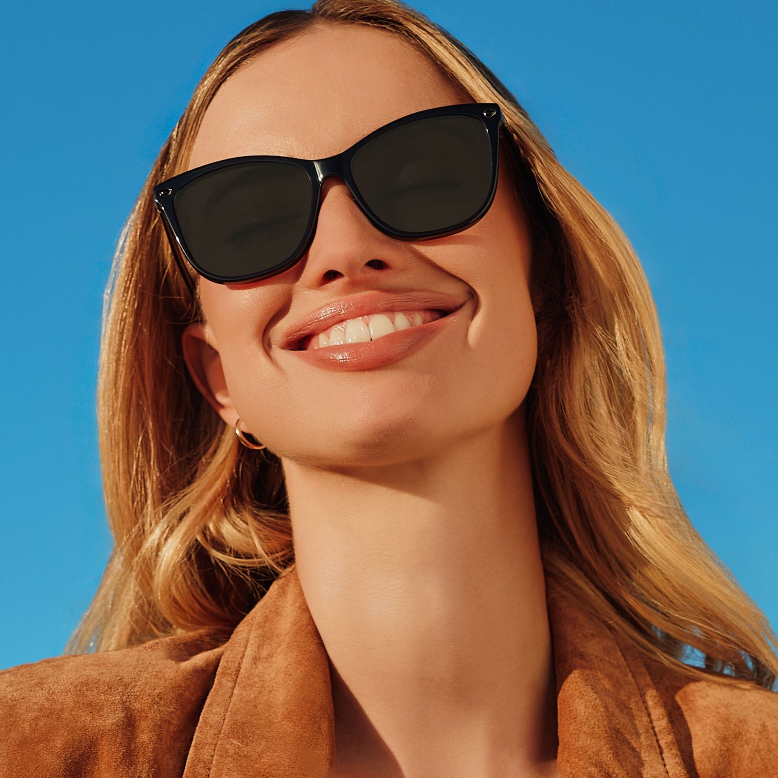 lifestyle - female wearing yellowstone x diff eyewear featuring the beth iii cat eye sunglasses with a black frame and grey lenses front view