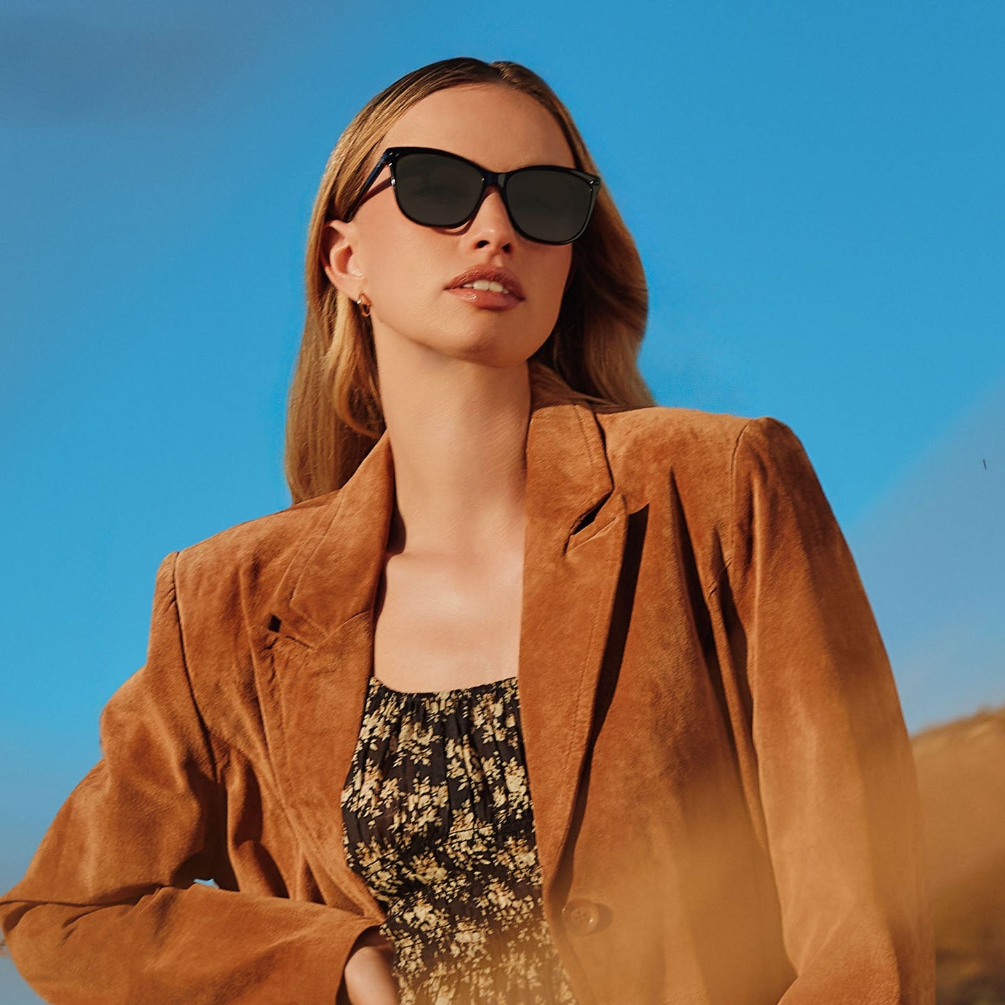 lifestyle - female wearing yellowstone x diff eyewear featuring the beth iii cat eye sunglasses with a black frame and grey lenses angled view