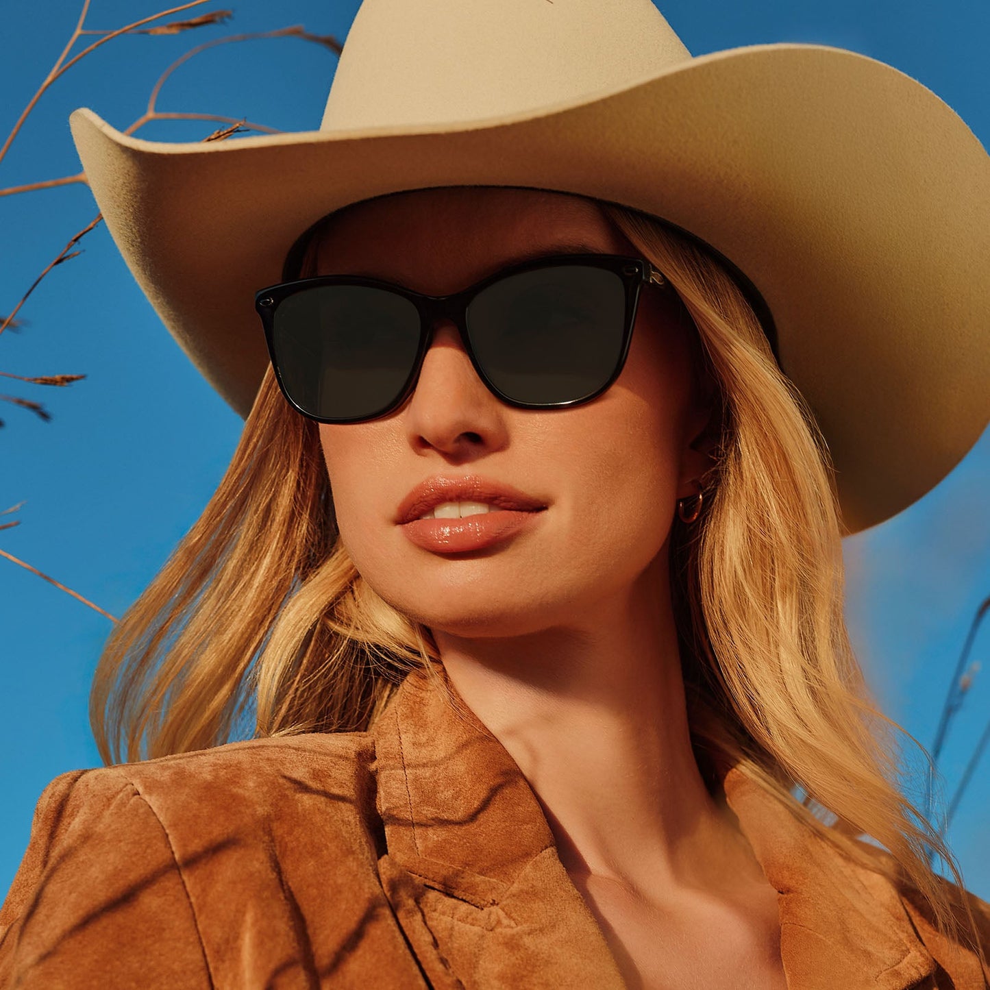 lifestyle - female wearing yellowstone x diff eyewear featuring the beth iii cat eye sunglasses with a black frame and grey lenses front view