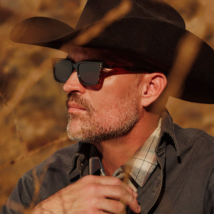 lifestyle - male with cowboy hat wearing yellowstone x diff eyewear featuring the john dutton rectangle sunglasses with a sequoia tortoise frame and brown polarized lenses detailed view