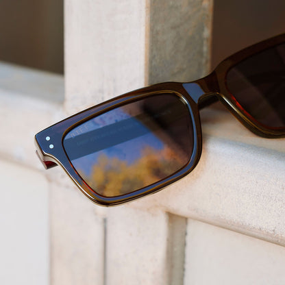 still life of yellowstone x diff eyewear featuring the john dutton rectangle sunglasses with a sequoia tortoise frame and brown polarized lenses front view