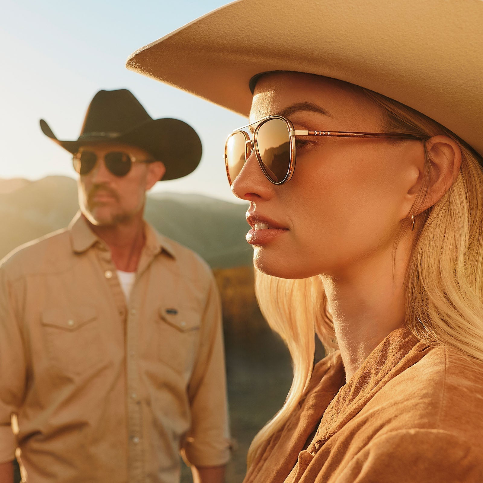 lifestyle - female in a cowboy hat wearing yellowstone x diff eyewear featuring the yellowstone aviator sunglasses with a sequoia tortoise frame and brown polarized lenses front view