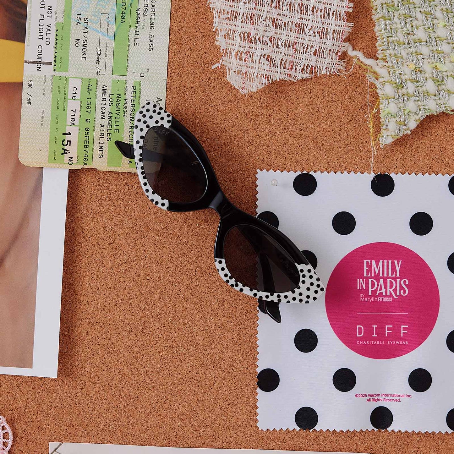 still life of emily in paris x diff eyewear featuring the emily 2.0 cat eye sunglasses with a midnight polka dot frame and chic grey lenses front view
