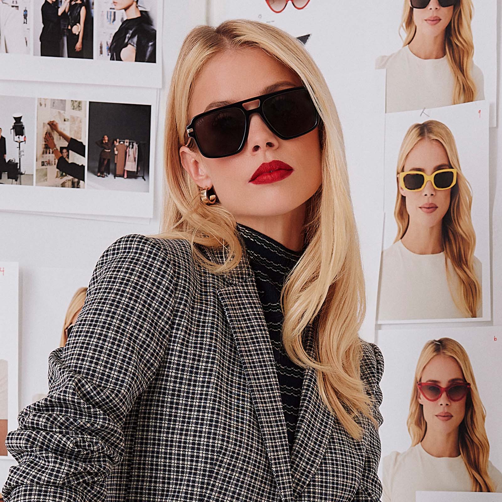 lifestyle - female in photo studio trying on emily in paris x diff eyewear featuring the julien navigator sunglasses with a jet noir black frame and smoke black lenses front view