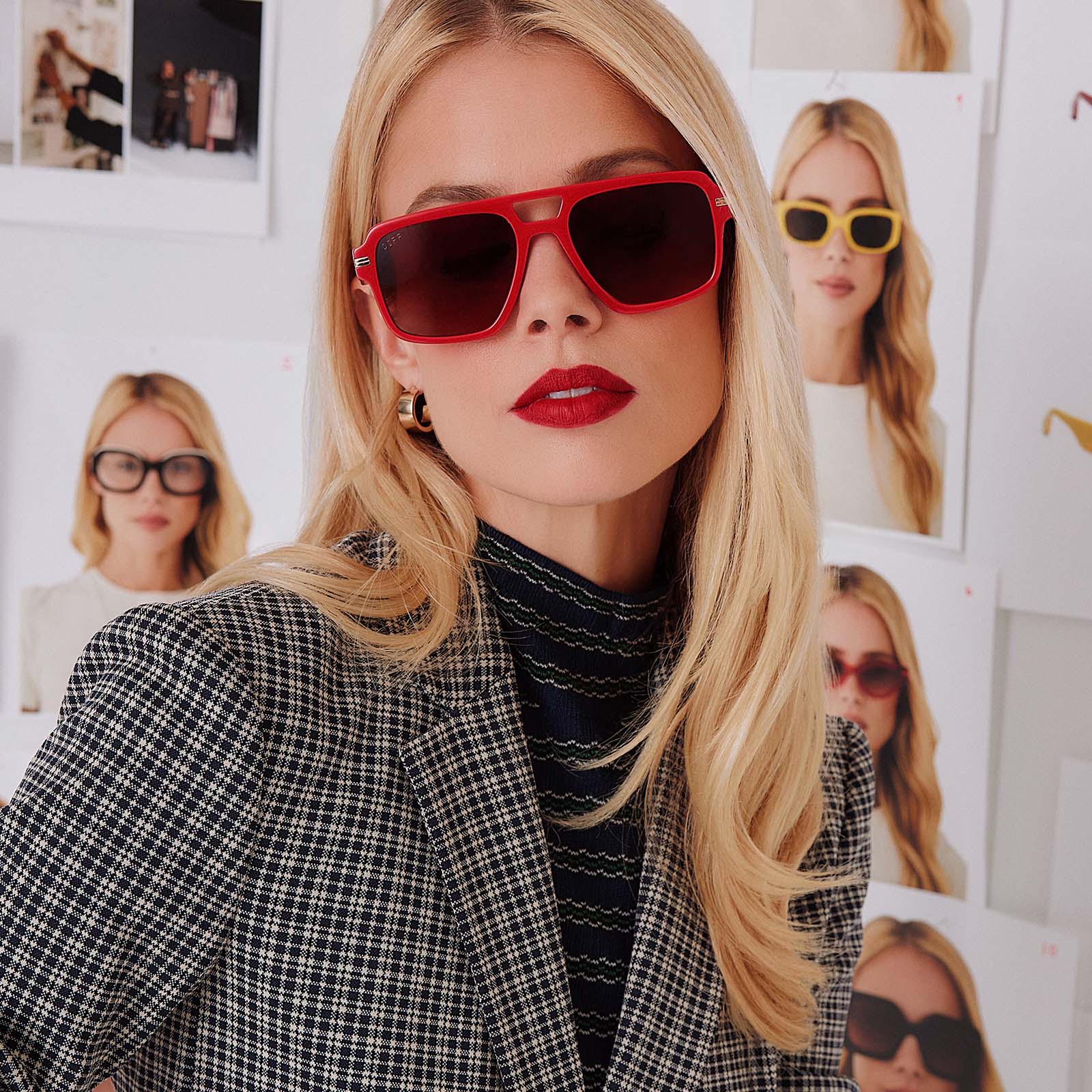 lifestyle - female in photo studio trying on emily in paris x diff eyewear featuring the julien navigator sunglasses with a rouge vogue red frame and warm brown gradient lenses front view