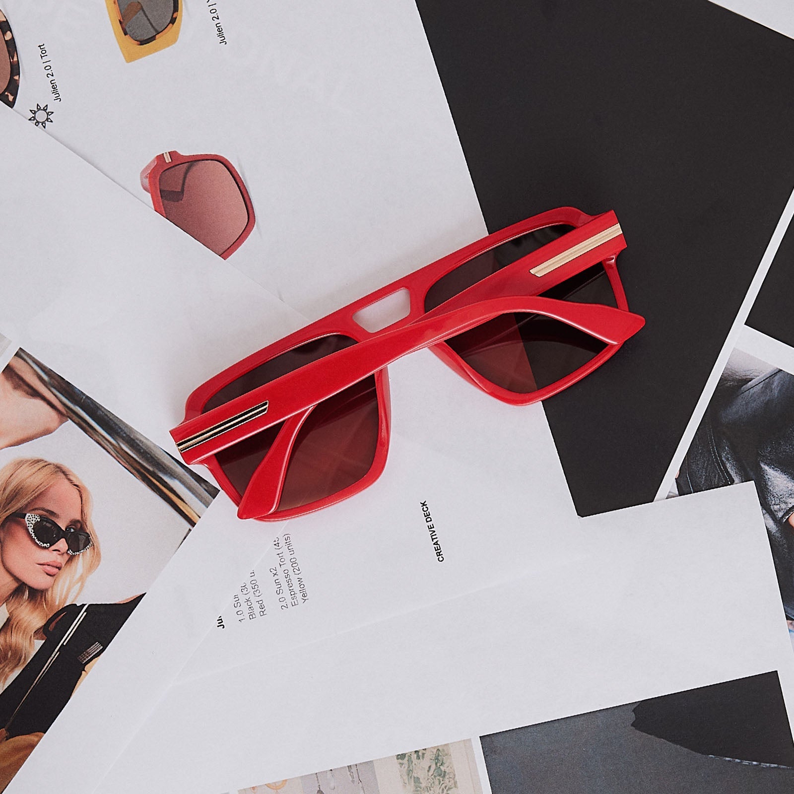 still life of emily in paris x diff eyewear featuring the julien navigator sunglasses with a rouge vogue red frame and warm brown gradient lenses detailed view