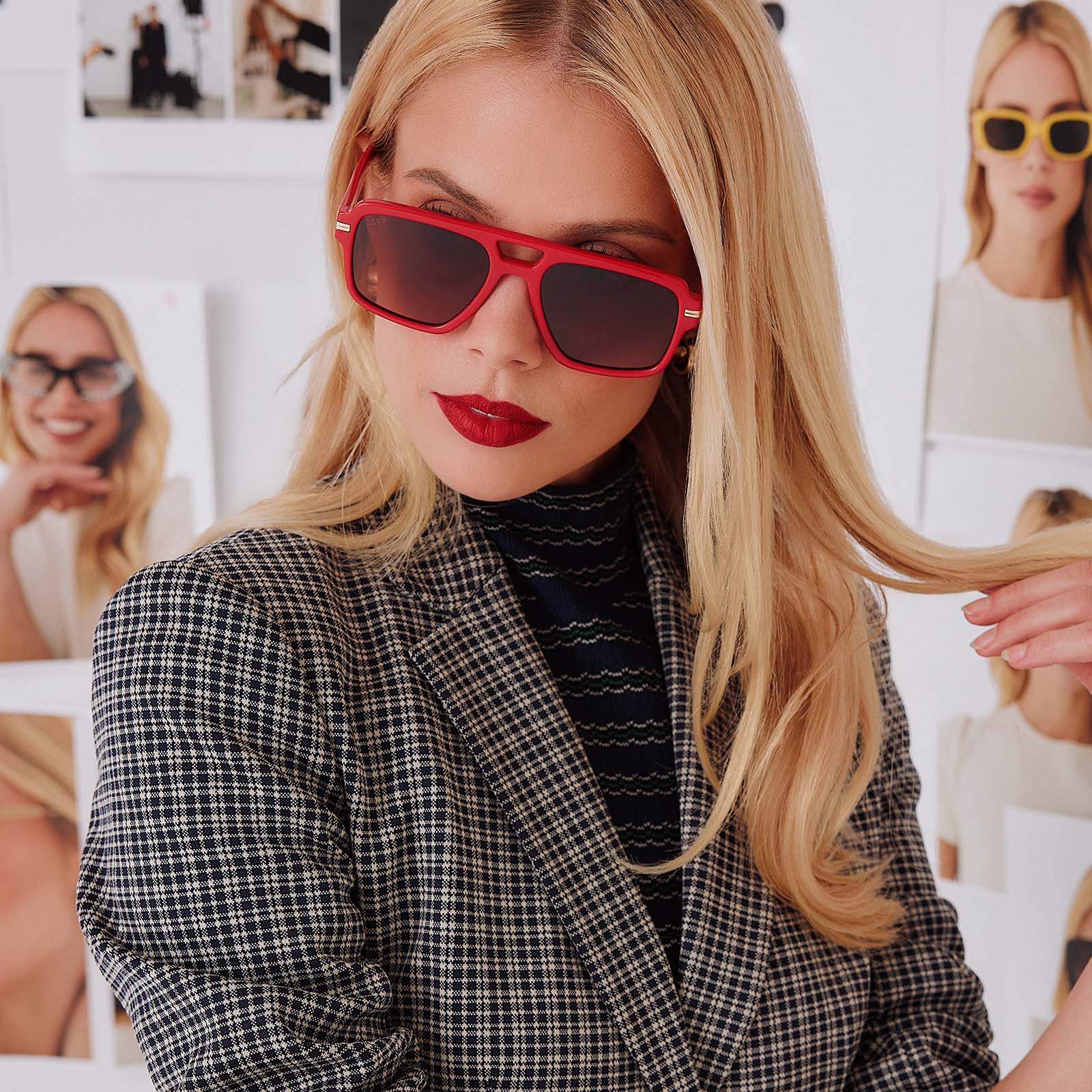 lifestyle - female in photo studio trying on emily in paris x diff eyewear featuring the julien navigator sunglasses with a rouge vogue red frame and warm brown gradient lenses front view